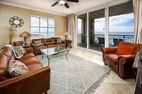 a living room with leather furniture and a view of the ocean at Bella Riva 301 Large Gulf Front condo in Fort Walton Beach