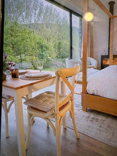 a bedroom with a table and a bed and a table and chair at Quinta das Levadas - Country House & Nature in Alvoco das Várzeas