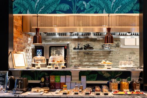 a kitchen with a counter with different types of food at Hulbert House Luxury Boutique Lodge Queenstown in Queenstown