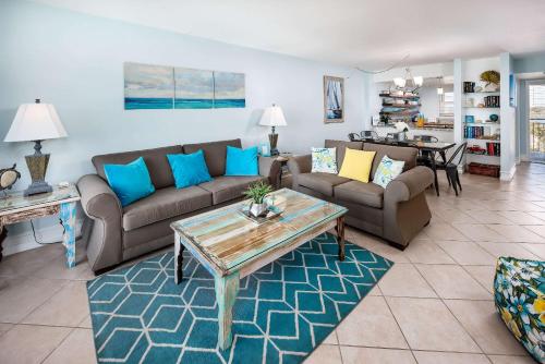 a living room with couches and a table at Emerald Isle 610 Beach Front condo in Fort Walton Beach