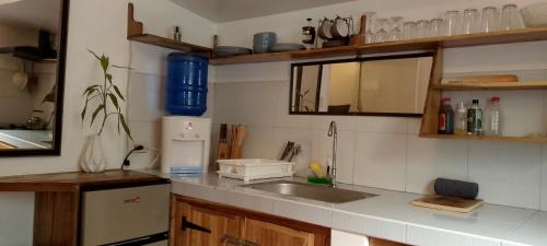 a kitchen with a sink and a counter top at Bungalow in El Nido