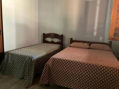 Postel nebo postele na pokoji v ubytování Chalé em Pacoti