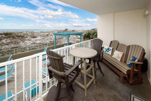 a balcony with a table and chairs and the ocean at Gulf Dunes 106 Gulf Front condo in Fort Walton Beach