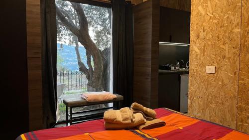 a bedroom with a bed and a large window at Sehayleh Chalet in Ḩayy ash Shabbūq