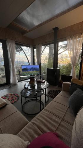 a living room with a couch and a table at Sehayleh Chalet in Ḩayy ash Shabbūq