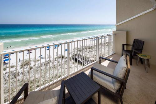 a balcony with chairs and a view of the beach at Gulf Side 602 Pet friendly gulf front condo in Fort Walton Beach