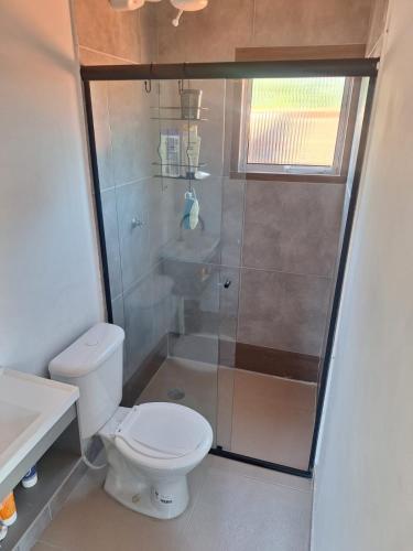 a bathroom with a shower with a toilet and a sink at Casa Boraceia Litoral Norte SP in São Sebastião