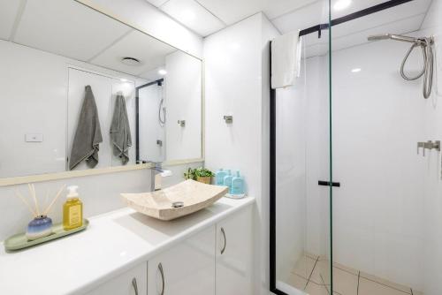 a bathroom with a sink and a shower at Nelson Towers- Overlooking The Bay in Nelson Bay