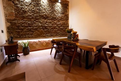 a dining room with a wooden table and chairs at Casa Sofi Oaxaca in Oaxaca City