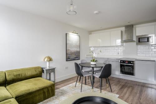 a living room with a couch and a table at Luxurious 2 Bedroom Apartment with Free Parking, Sky TV, Sports, Movies & Netflix in Chelmsford