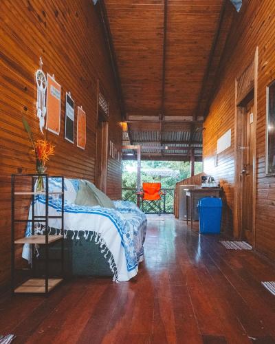 a bedroom with a bed and a desk in a room at Casa Aldirica in Cahuita