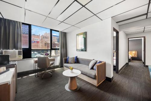 a living room with a couch and a table at Eminence on Bank in Adelaide