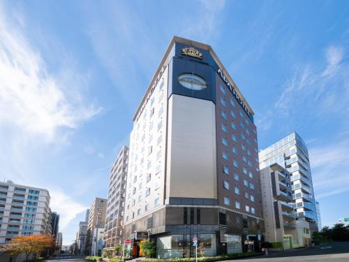 a building with a clock on the side of it at APA Hotel Nihonbashi Hamacho Ekiminami in Tokyo