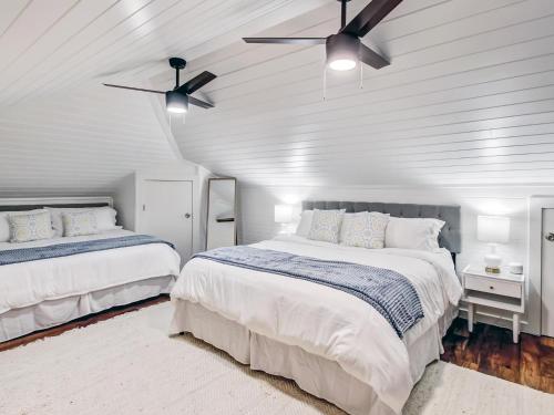 a bedroom with two beds and a ceiling fan at Beachside Villa Unit 4 in Tybee Island