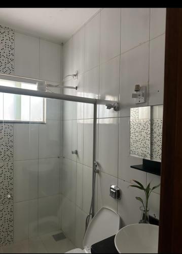 a bathroom with a shower and a toilet and a sink at Casa da paz in Palmas