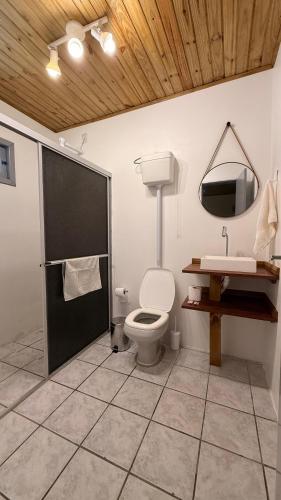 a bathroom with a toilet and a sink at Pousada Sol e Mar in Farol de Santa Marta