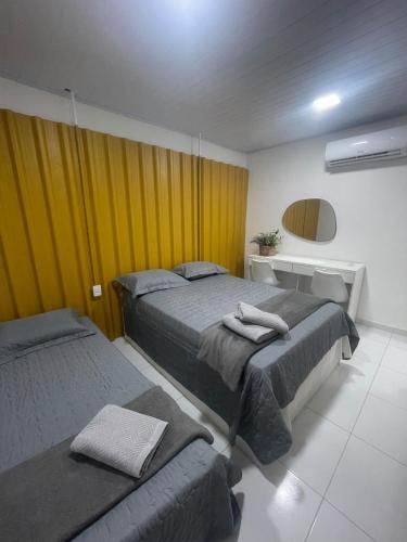 a hotel room with two beds and a sink at Apto aconchegante na Boa Vista - 2 Quartos - Perto Consulado in Recife