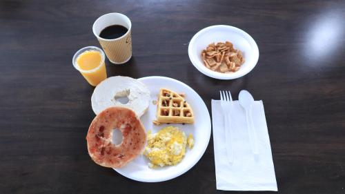 布莱斯维尔Americas Best Value Inn Suites & Studios Blytheville by Sonesta的餐桌,早餐盘和咖啡