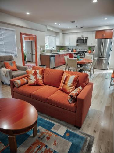 a living room with a couch and a kitchen at Hollywood Living 3 to 5 BR Townhomes with Free Parking in Los Angeles