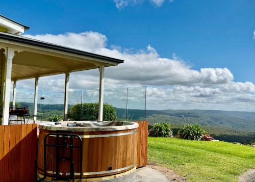 a hot tub on the side of a house at The Quince Cottage - 2 Bedrooms in Ravensbourne