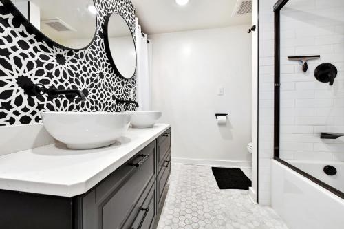 a bathroom with two sinks and a mirror at Peak View Guesthouse - Walk to Garden of the Gods - Hot Tub - Epic Views! in Colorado Springs
