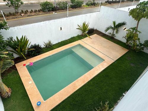 a swimming pool in the middle of a yard at Private Canarian house with pool in Conkal