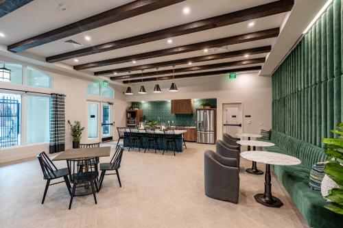 a restaurant with tables and chairs in a room at The Village Collection with Gym Pool and Spa in Montclair