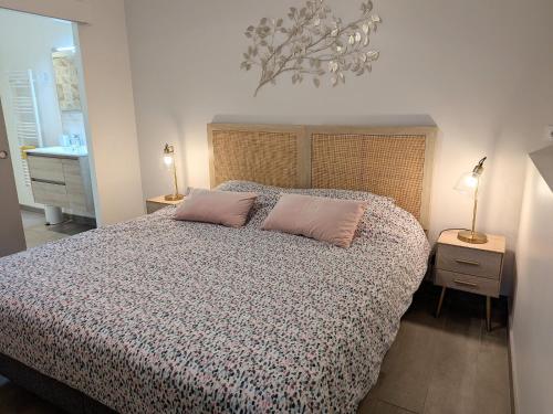 a bedroom with a bed with two pillows on it at Charmant gîte à la ferme avec terrasse et vue sur la mare - FR-1-590-540 in Chilleurs-aux-Bois