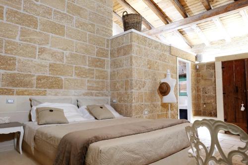 Ένα ή περισσότερα κρεβάτια σε δωμάτιο στο Masseria Costa