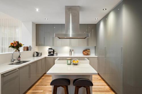 a kitchen with a white counter and a sink at Charming Red Brick Estate in Kew 5BR & Playhouse in Melbourne