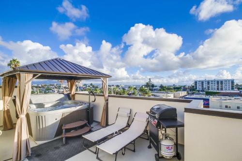 a balcony with a hot tub and a gazebo at Park Blvd Paradise 303 king bed With a private Spa in San Diego