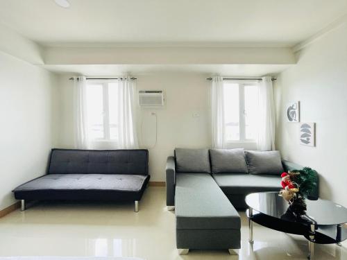 a living room with a couch and a coffee table at Elegant Style Studio in SMDC in Cari Mayor