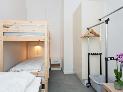 a bedroom with a bunk bed and a bath tub at Bright Seaside Apartment in Ebeltoft in Ebeltoft