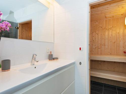 a bathroom with a sink and a mirror at Bright Seaside Apartment in Ebeltoft in Ebeltoft