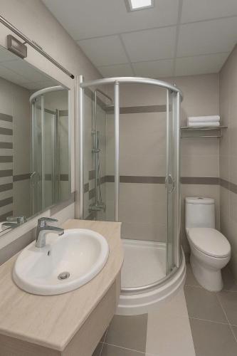 a bathroom with a sink and a shower and a toilet at Van Ha Hotel Etown - Nhà Ga T3 Sân Bay TSN in Ho Chi Minh City