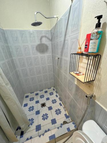 a bathroom with a toilet and a tile floor at Modern Loft #1 in Puerto Barrios