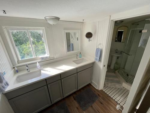 a bathroom with two sinks and a shower at Old Florida Charm in Eustis