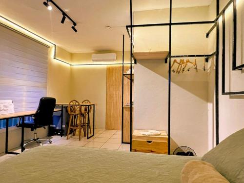 a bedroom with a bed and a desk with a chair at Modern Loft #1 in Puerto Barrios