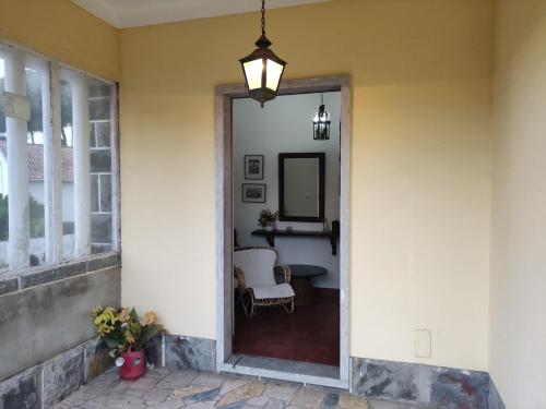 a hallway of a home with a mirror and a table at Classic 3BR Sintra Home near Beaches & Palaces in Colares