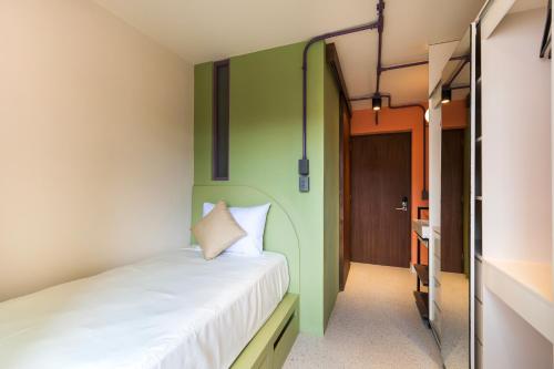 Ένα ή περισσότερα κρεβάτια σε δωμάτιο στο Nico Hotel & Residences