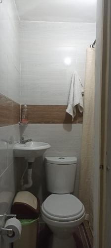 a bathroom with a white toilet and a sink at My second house in Manizales