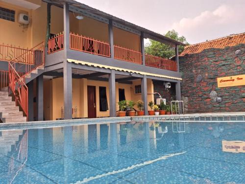 a large swimming pool in front of a building at Grand Ciwareng Inn Hotel and Resort in Pasarsenen