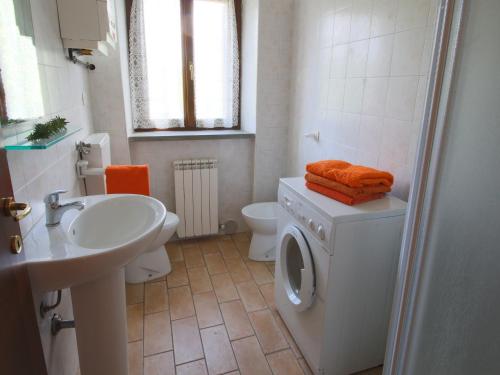 a bathroom with a washing machine and a sink at Mansion in Apecchio with Pool in Apecchio