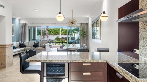 an open kitchen and living room with a large island at Beautiful Apartment a few of minutes to the Beach in Cabo San Lucas