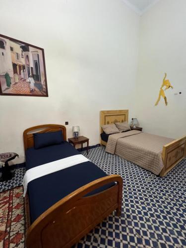 Ένα ή περισσότερα κρεβάτια σε δωμάτιο στο Riad Dar Babouche
