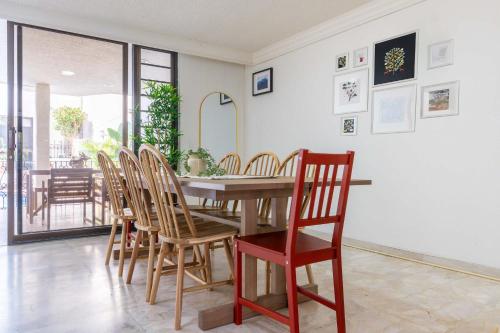 a dining room with a wooden table and chairs at Family Home with Private Pool in Guadalajara