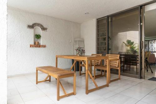 a dining room with a wooden table and chairs at Family Home with Private Pool in Guadalajara