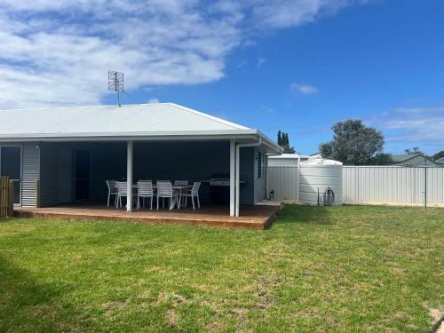 a house with a porch with a table and chairs at Solmar Siesta - WiFi Pet Friendly Outside in Robe