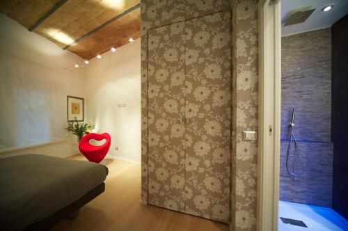 ein Schlafzimmer mit einem Bett und einem roten Stuhl in der Unterkunft Fico Blu in Rom