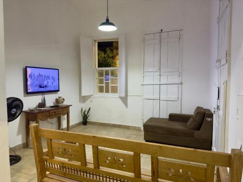 a living room with a couch and a window at Casarão Centenário in Passos